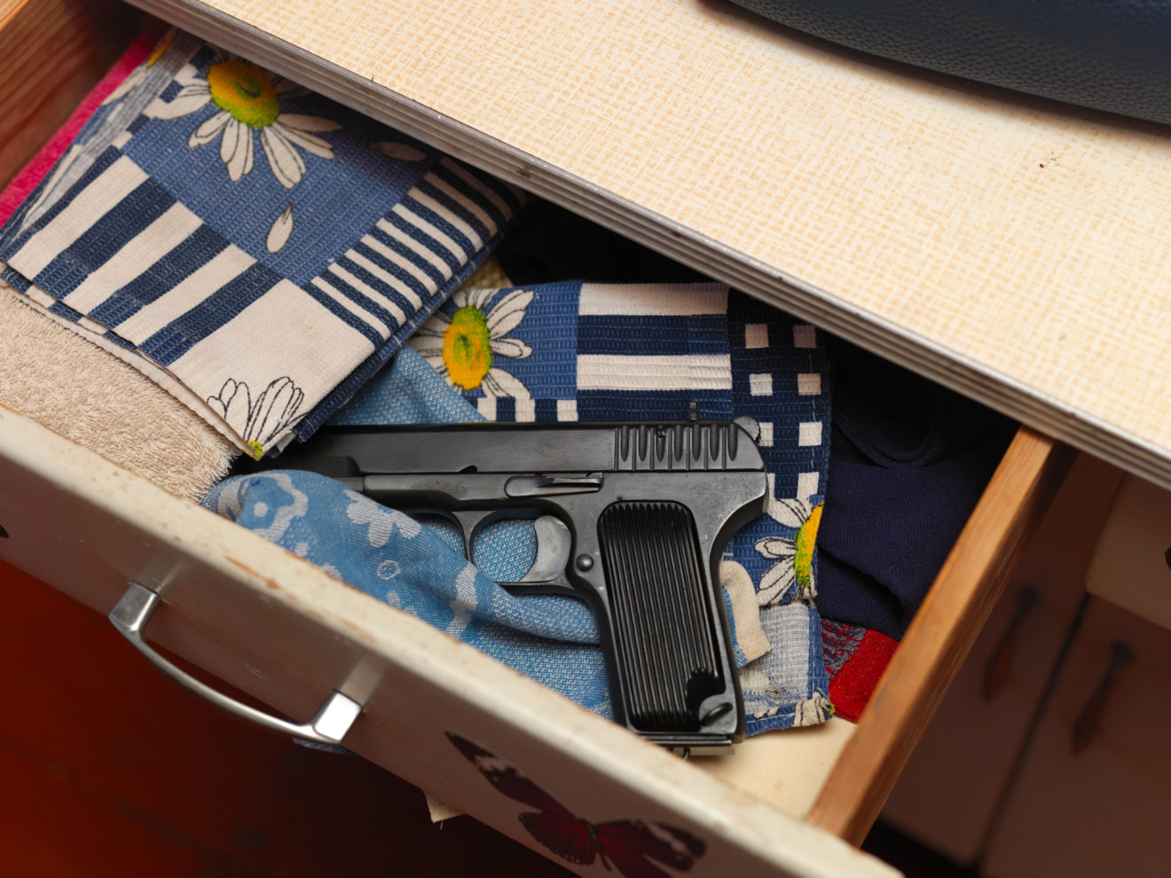 handgun in a cupboard drawer