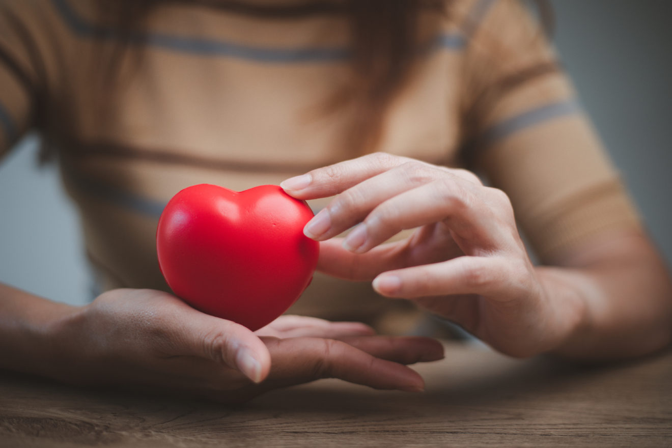 feMale hands holding red heart, world mental health day and worl